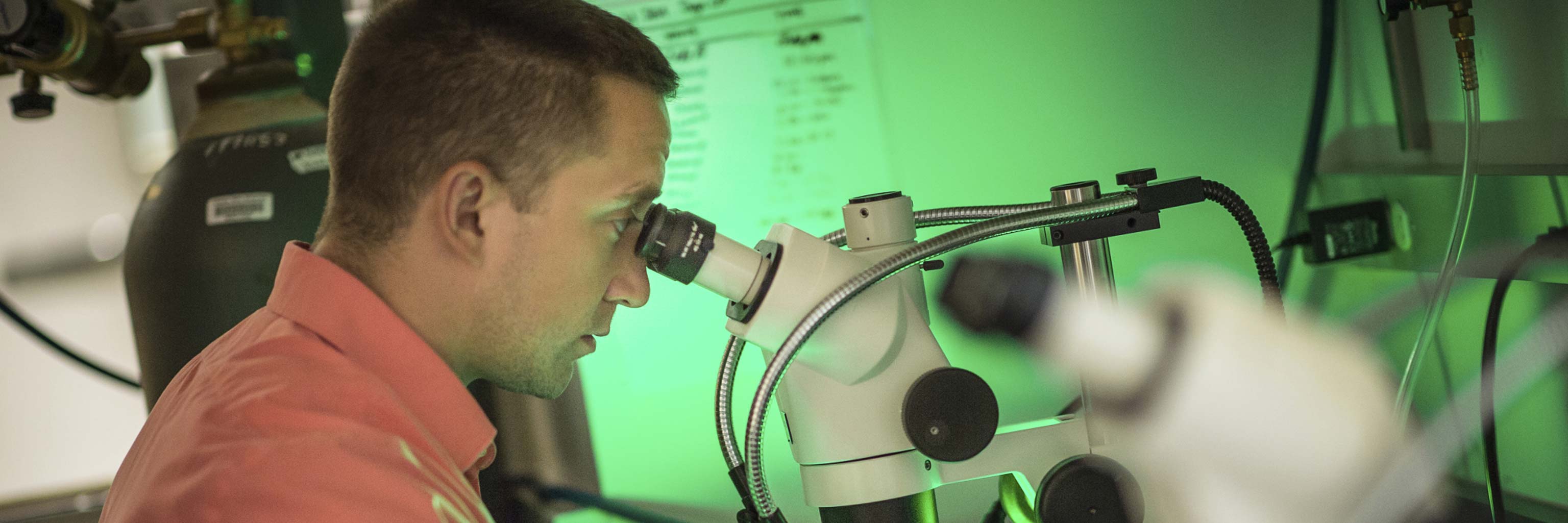 man looking into a microscope