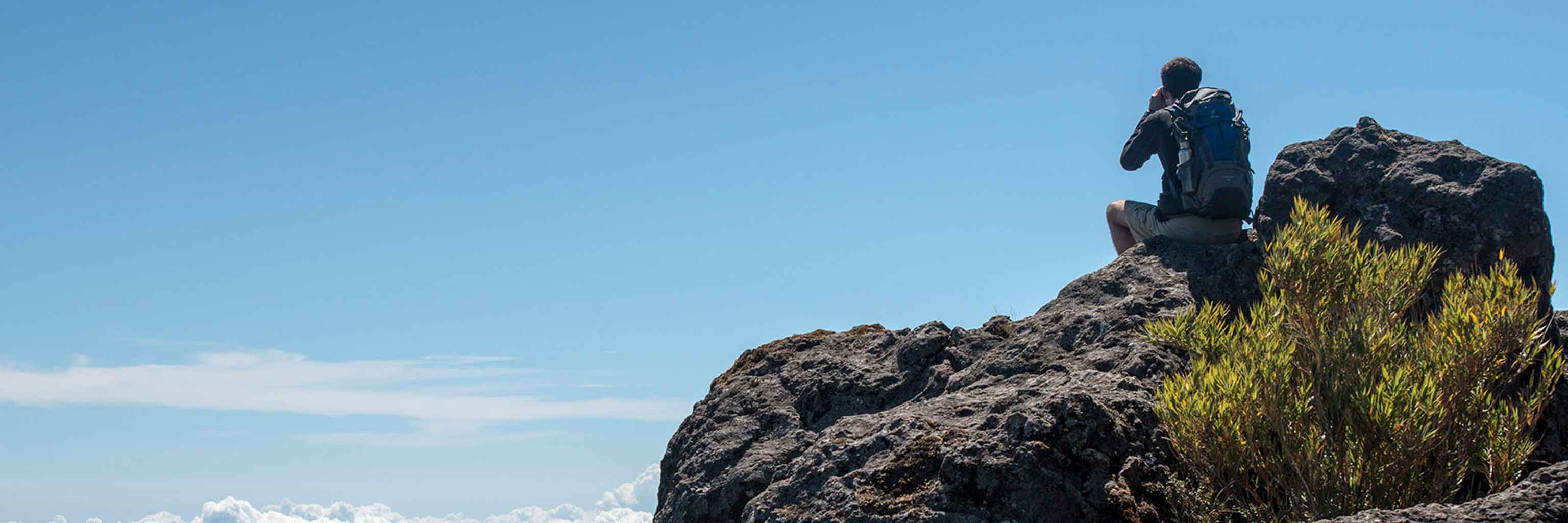 Male sitting by a mountain in Costa Rica