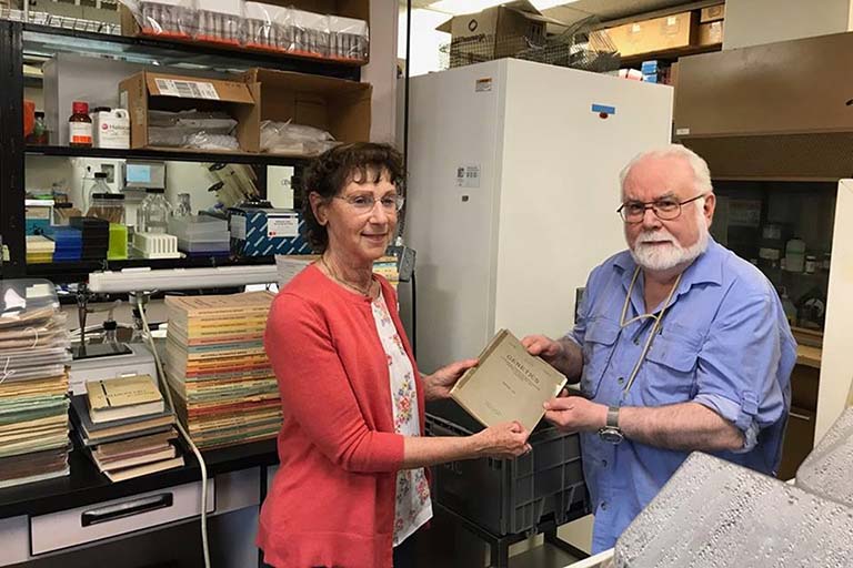 IU Distinguished Professor of Biology Thom Kaufman hands off collection of historically significant Drosophila research documents to Elise Calvi of the Lilly Library.