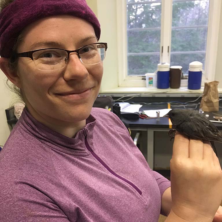 Katie Talbott holding a junco.