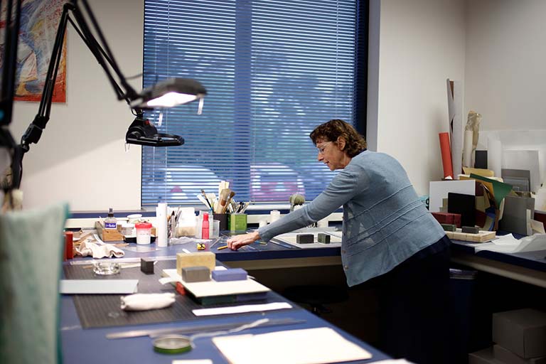 Elise Calvi works with the collection of historically significant Drosophila research documents in the Lilly Library preservation room.