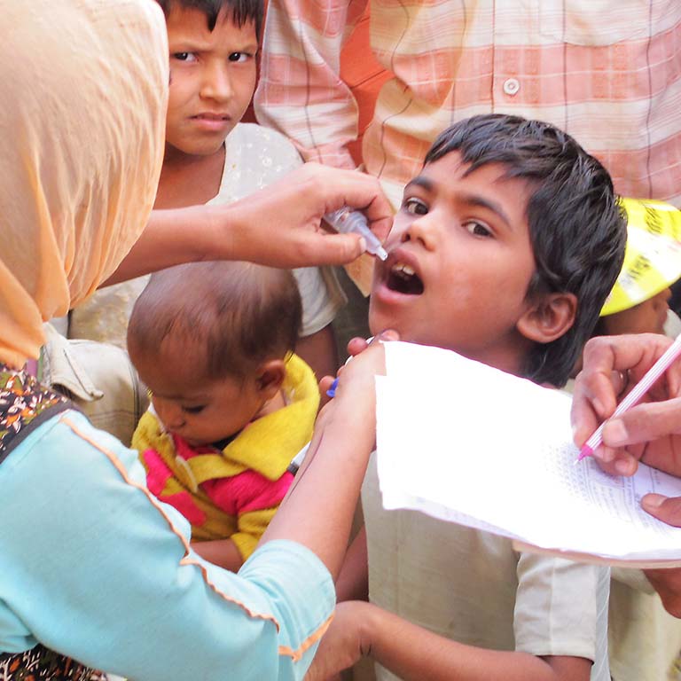 The oral polio vaccine being given to a boy.