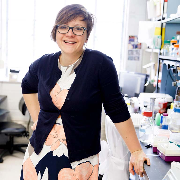 Amelia Randich standing in the lab.