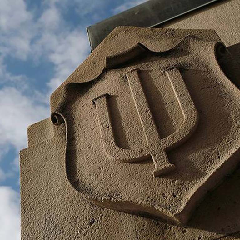 IU trident engraved in limestone.