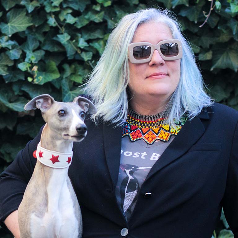 Sue Anne Zollinger holding her canine companion "x-ray."