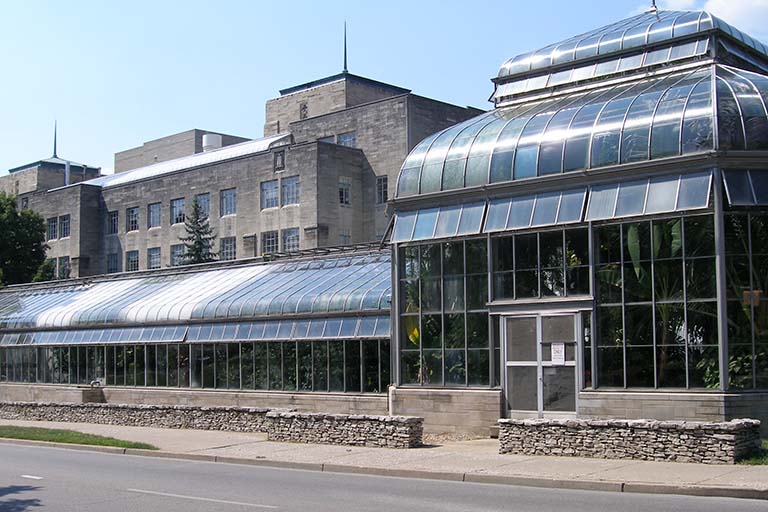 Its many plants from around the world are seen from the outside through the glass walls of the Jordan Hall greenhouse along East Third Street on the Indiana University Bloomington campus.